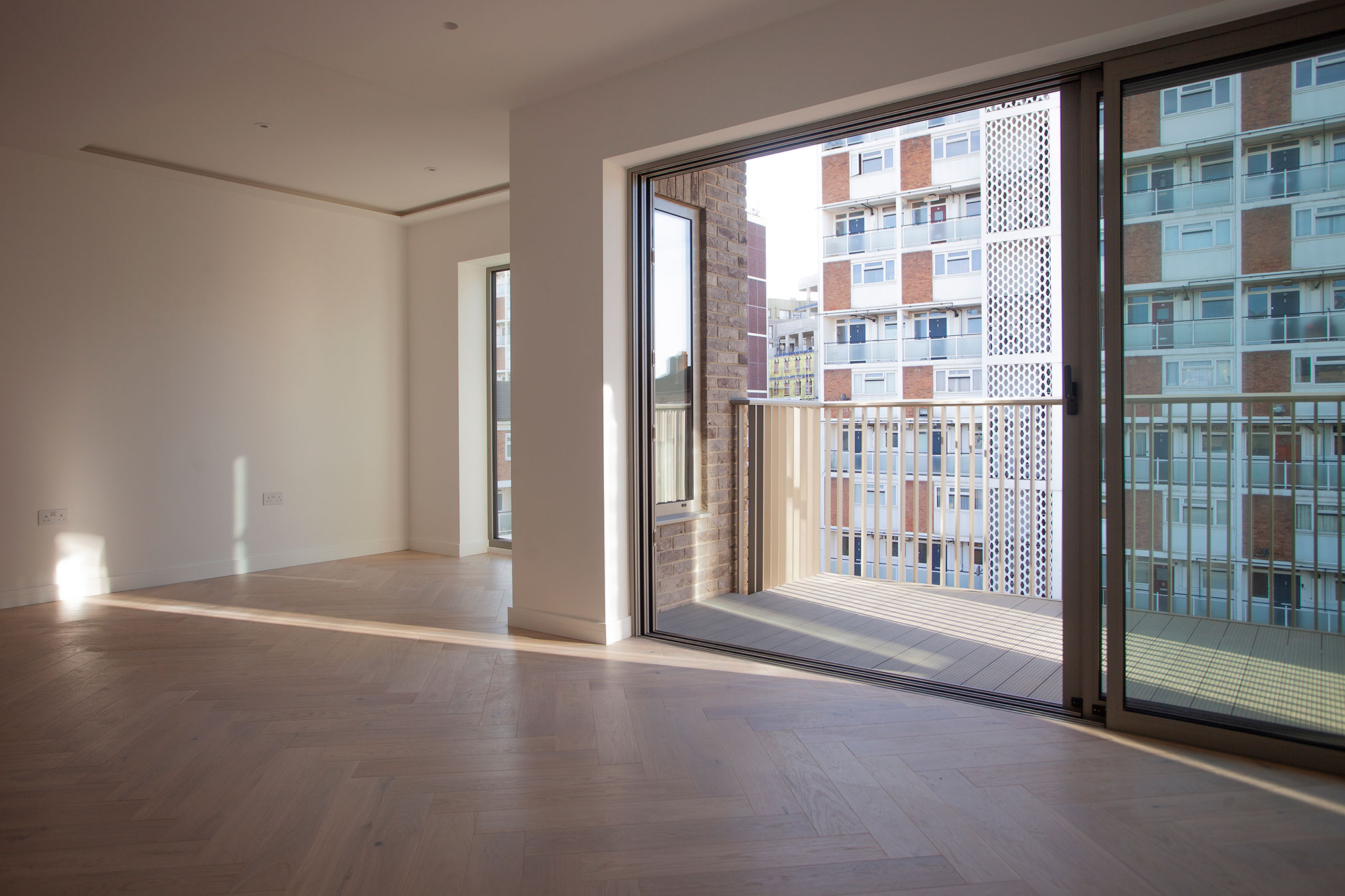 Living room and balcony view to outside area in London